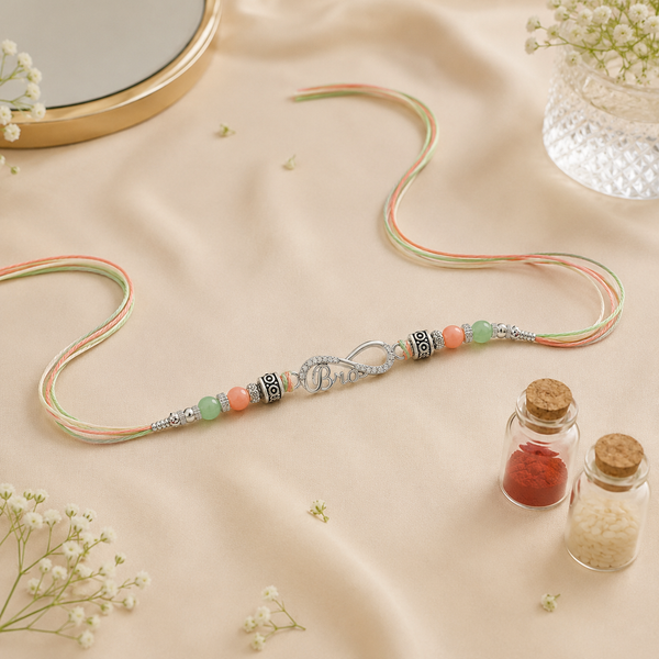 Bro Infinity Rakhi – 925 Sterling Silver Infinity Rakhi with Pastel Green & Peach Beads