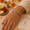 Krishna Rakhi – 925 Sterling Silver Rakhi with Green Crystal & Rudraksha Beads