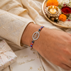 Radhe Radhe Rakhi – 925 Sterling Silver Divine Radhe Radhe Rakhi with Ruby & Royal Blue Crystal Beads