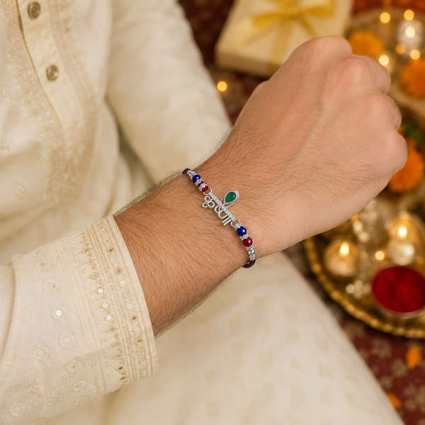 Krishna Rakhi – 925 Sterling Silver Rakhi with Green Crystal & Red Blue Beads