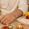 Om Rakhi – 925 Sterling Silver Divine Om Rakhi with Ruby & Golden Crystal Beads