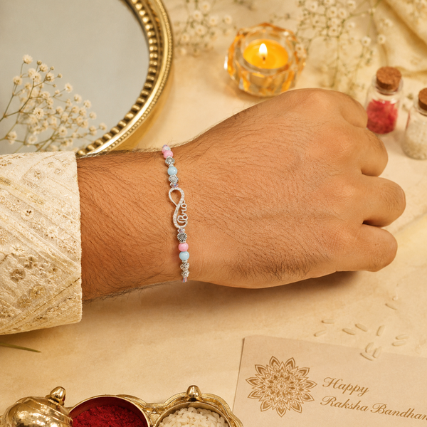 Bro Infinity Rakhi – 925 Sterling Silver Infinity Rakhi with Pastel Blue & Pink Beads