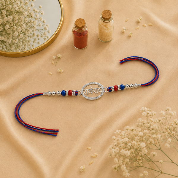 Radhe Radhe Rakhi – 925 Sterling Silver Divine Radhe Radhe Rakhi with Ruby & Royal Blue Crystal Beads
