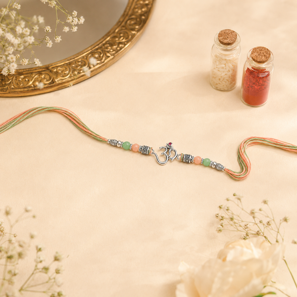 Om Rakhi – 925 Sterling Silver Om Rakhi with Pastel Green & Peach Beads